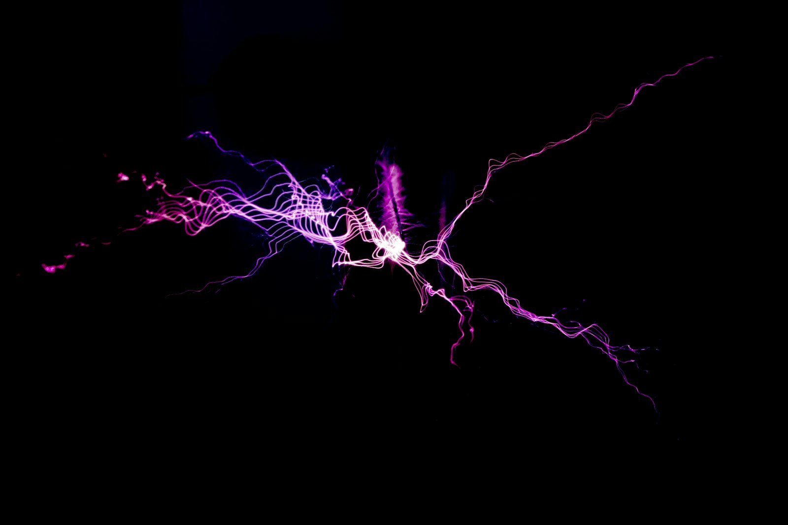 An electrical discharge glowing violet against darkness