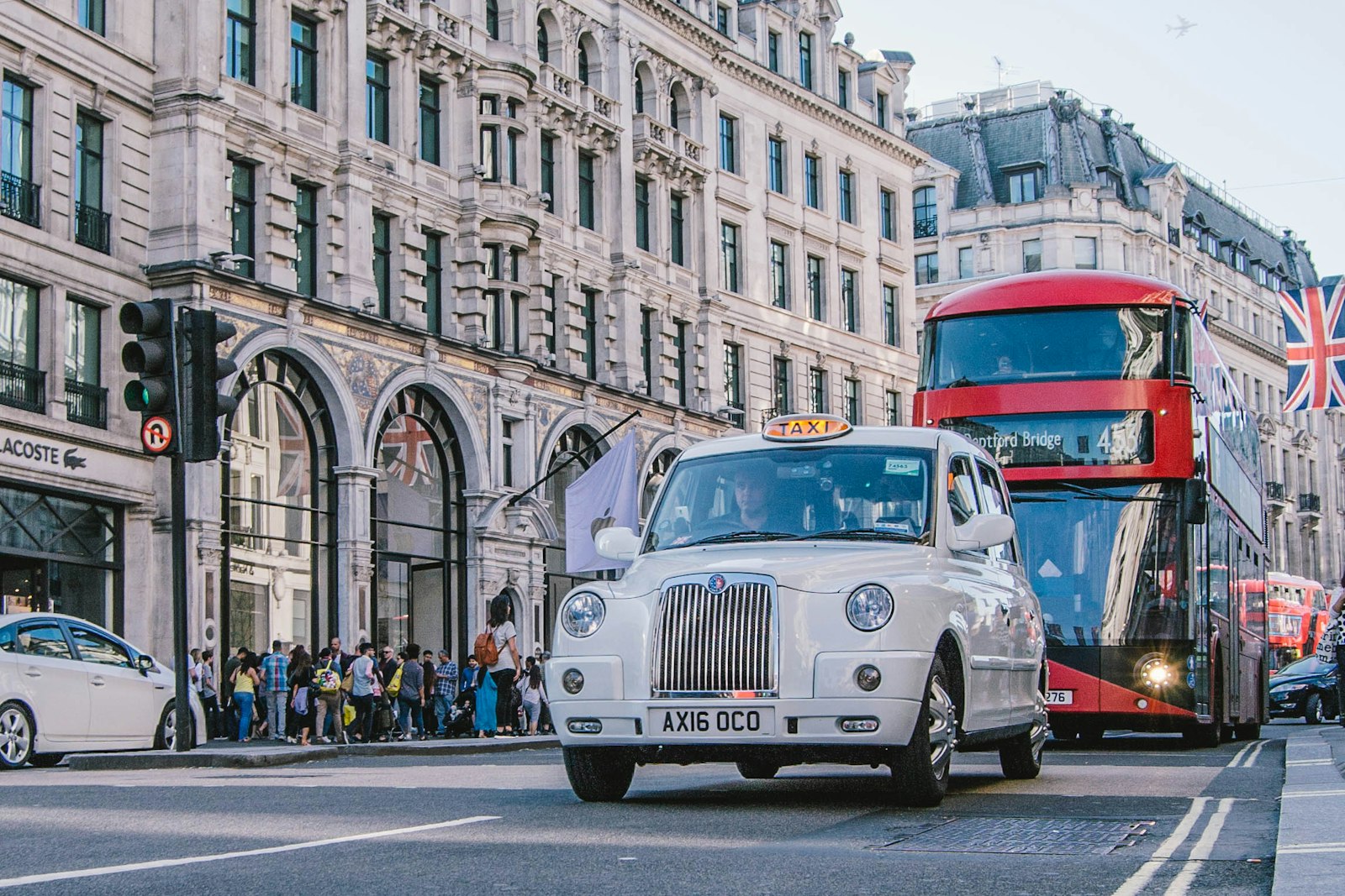 A London street with a red bus and black cab